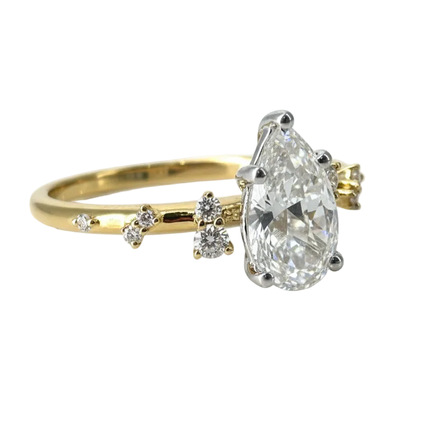 Gold ring with a large diamond and smaller diamonds on a light gray background