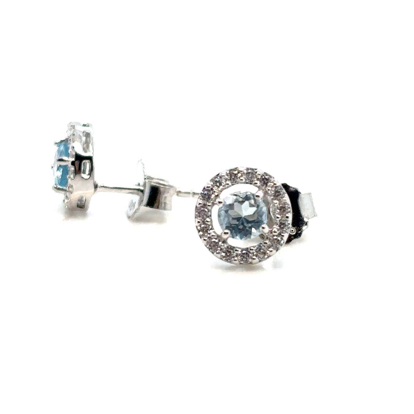 Round Sky Blue Topaz Halo Stud Earrings Set In Sterling Silver With Cubic Zirconia