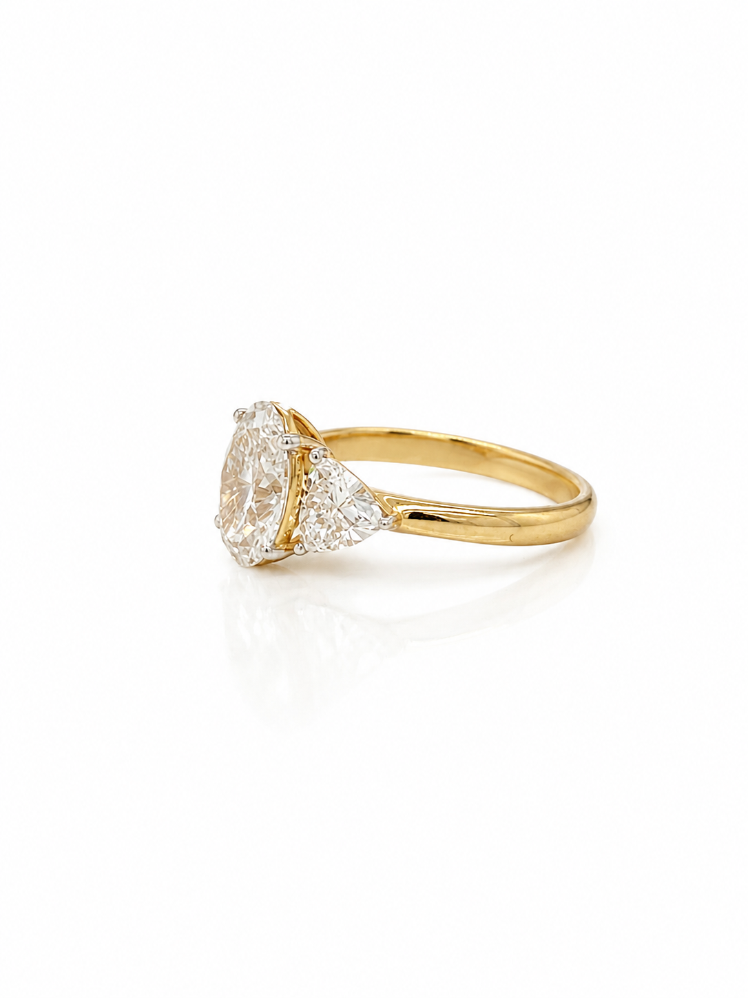 Oval and Trilliant Cut Diamond Trilogy Ring in Yellow Gold