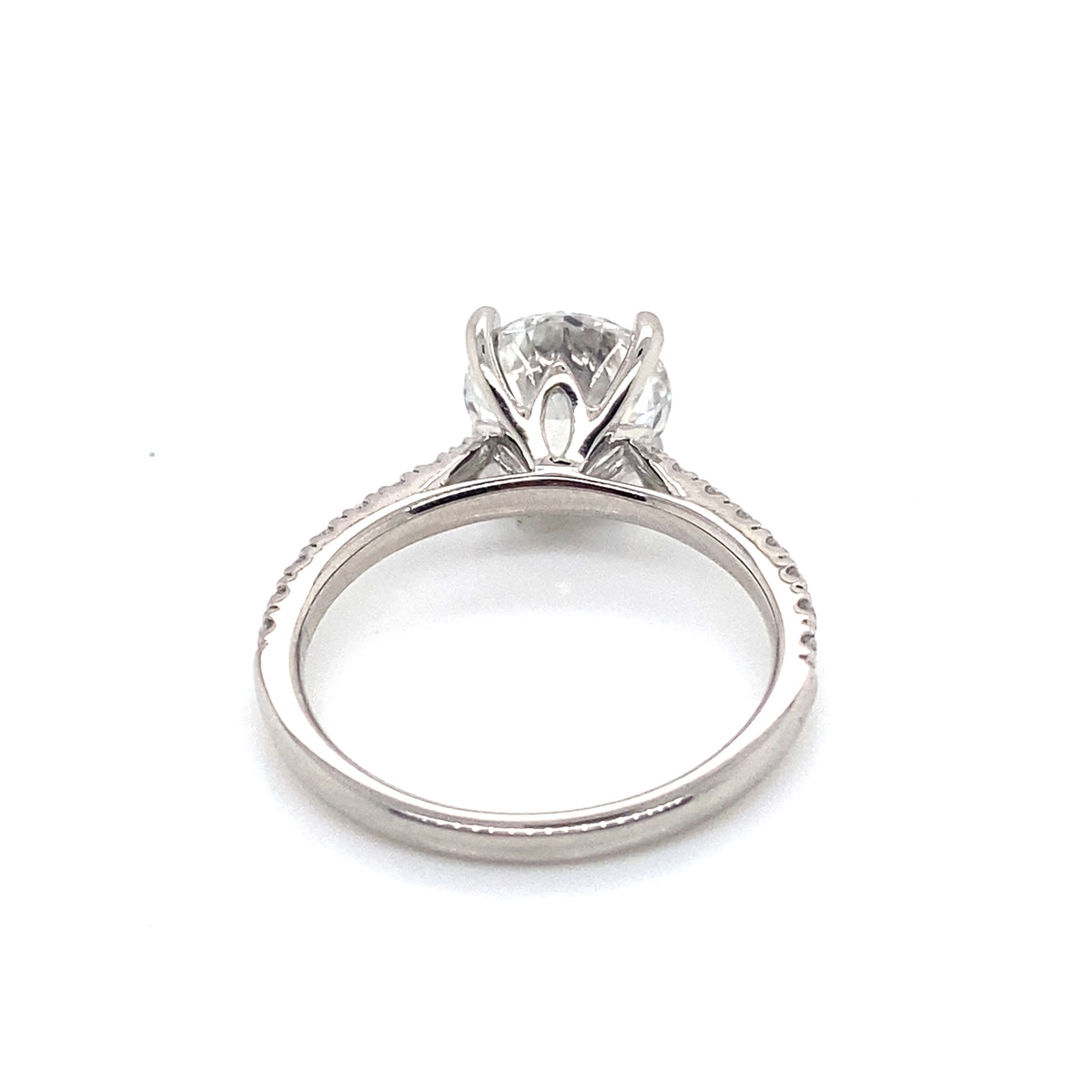 002046: platinum solitaire round cut diamond with pave set shoulders, tightened centre stone