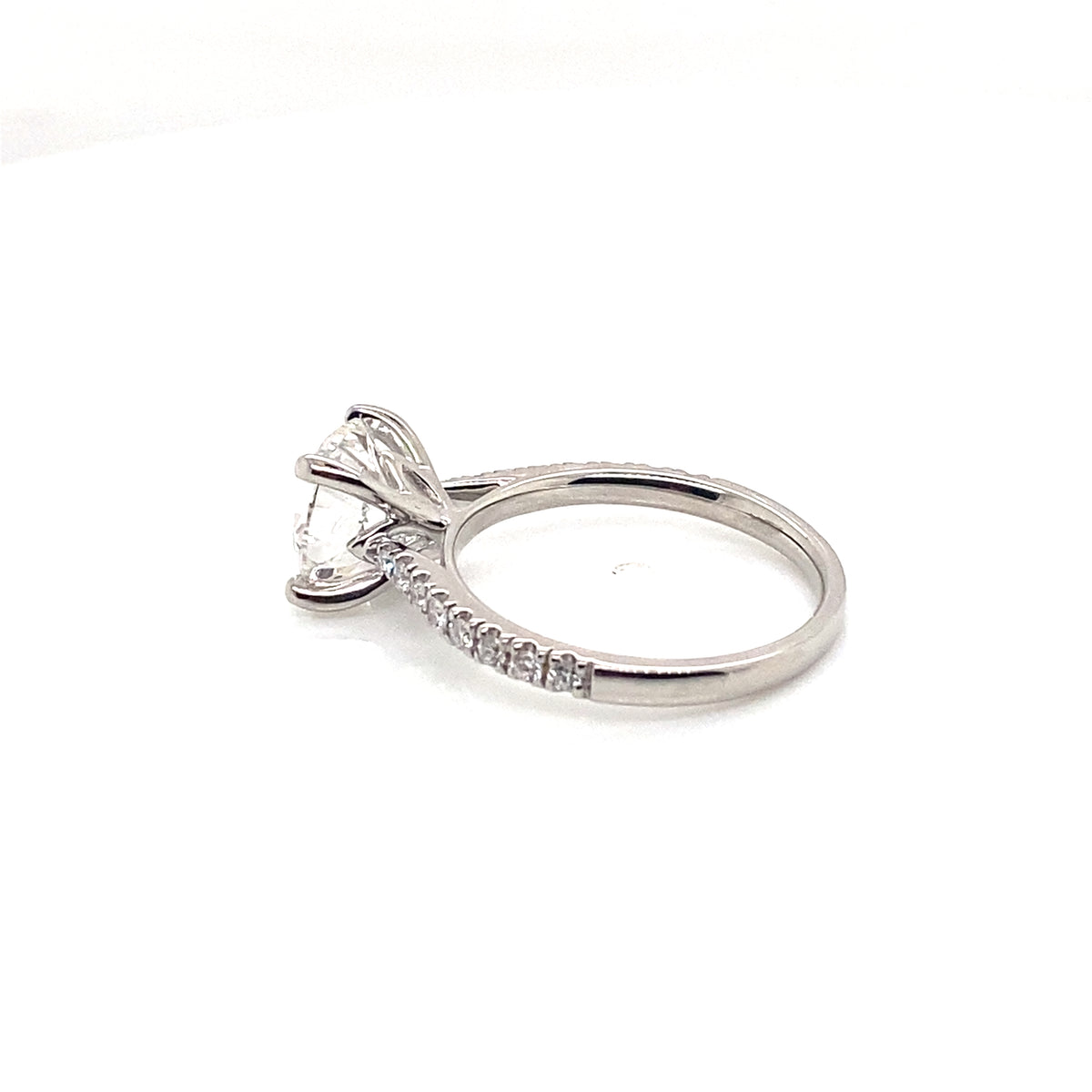 002046: platinum solitaire round cut diamond with pave set shoulders, tightened centre stone
