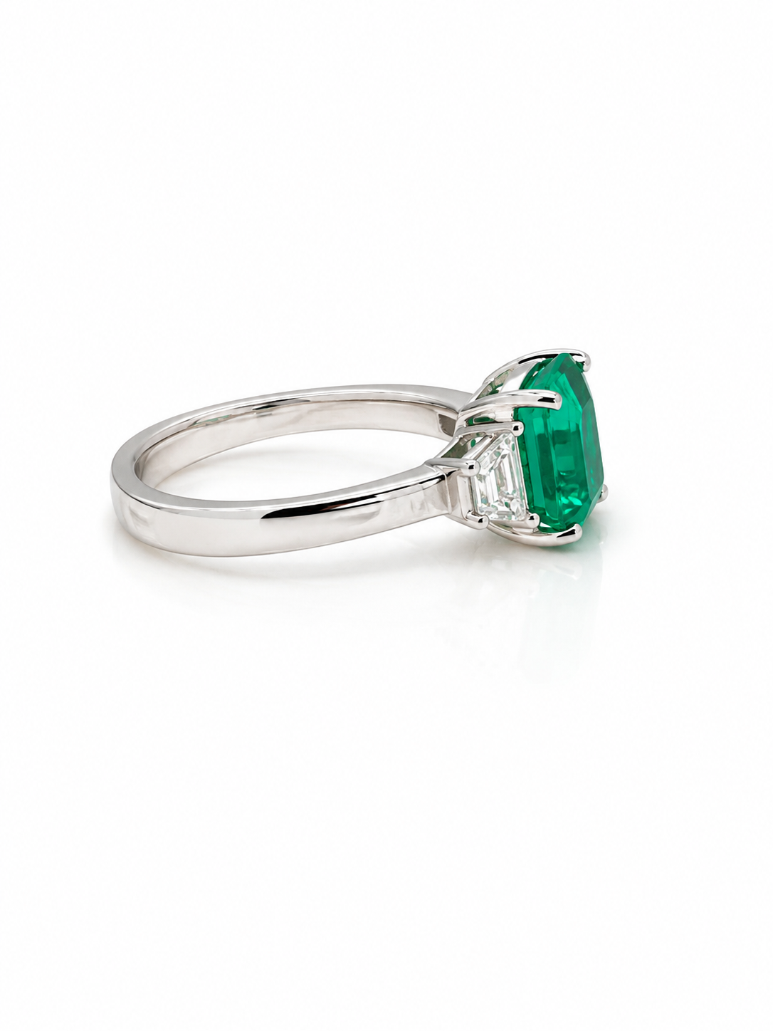 Emerald and Trapezoid Diamond Trilogy Ring in Platinum