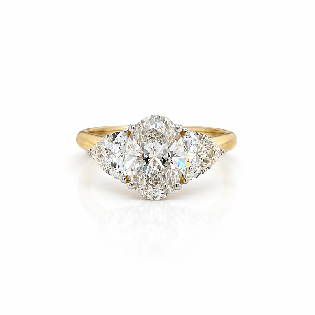 Oval and Trilliant Cut Diamond Trilogy Ring in Yellow Gold