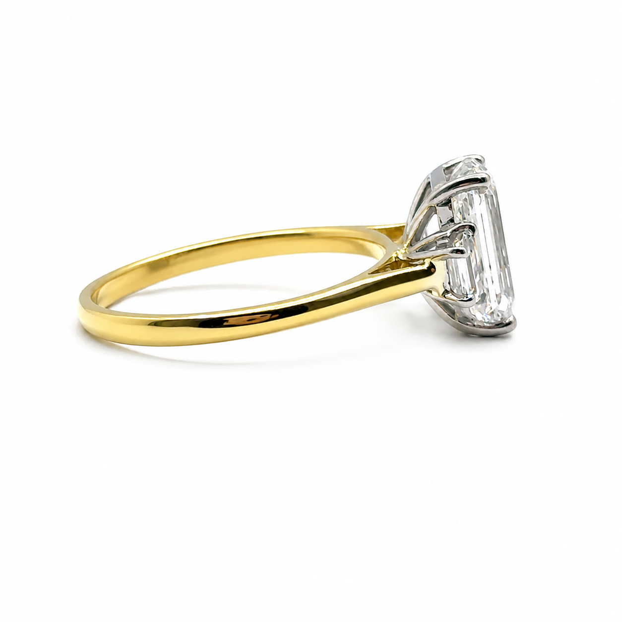 3ct Emerald Cut Diamond and Trapezoid Diamond Trilogy Ring in 18ct Yellow Gold with White Gold Head