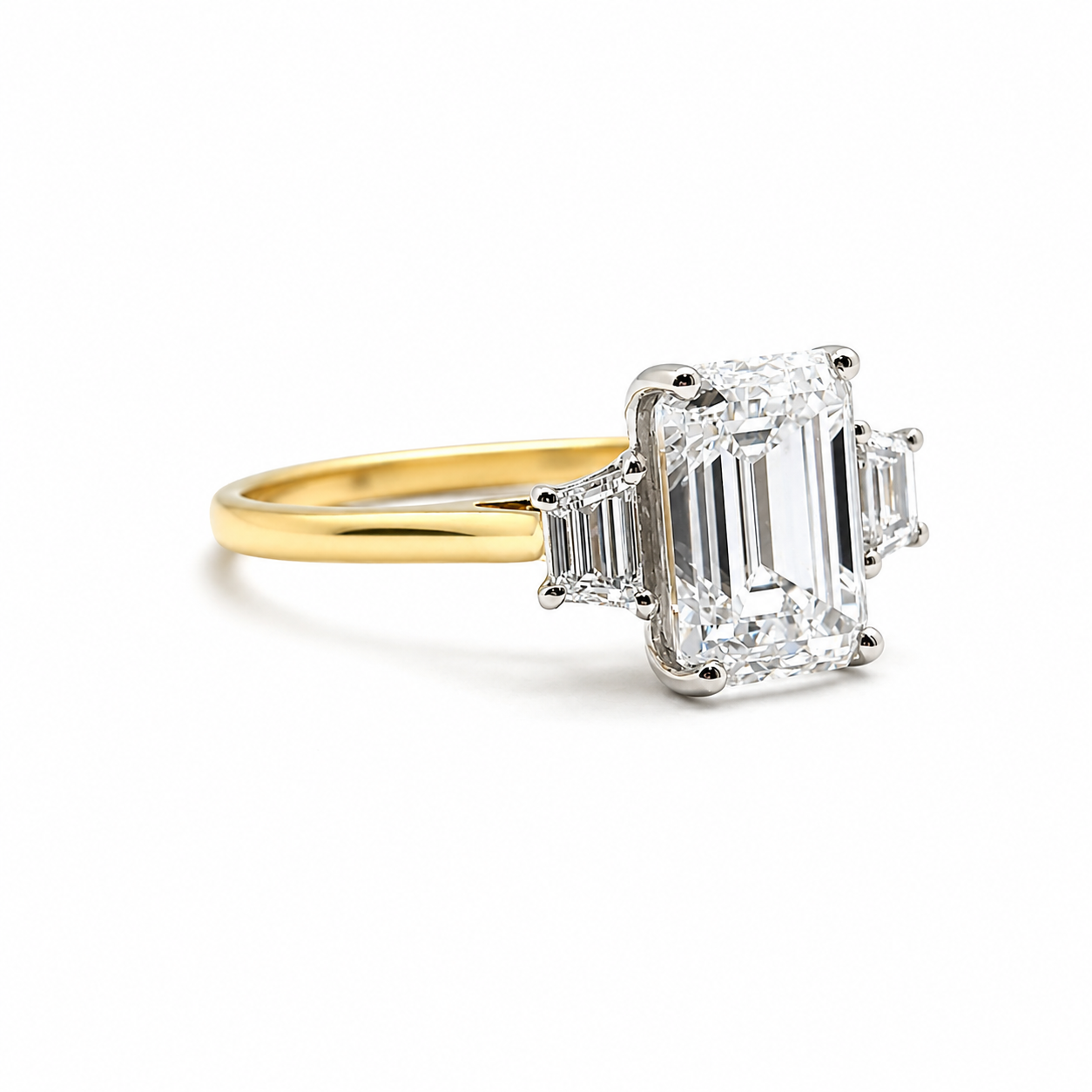 3ct Emerald Cut Diamond and Trapezoid Diamond Trilogy Ring in 18ct Yellow Gold with White Gold Head