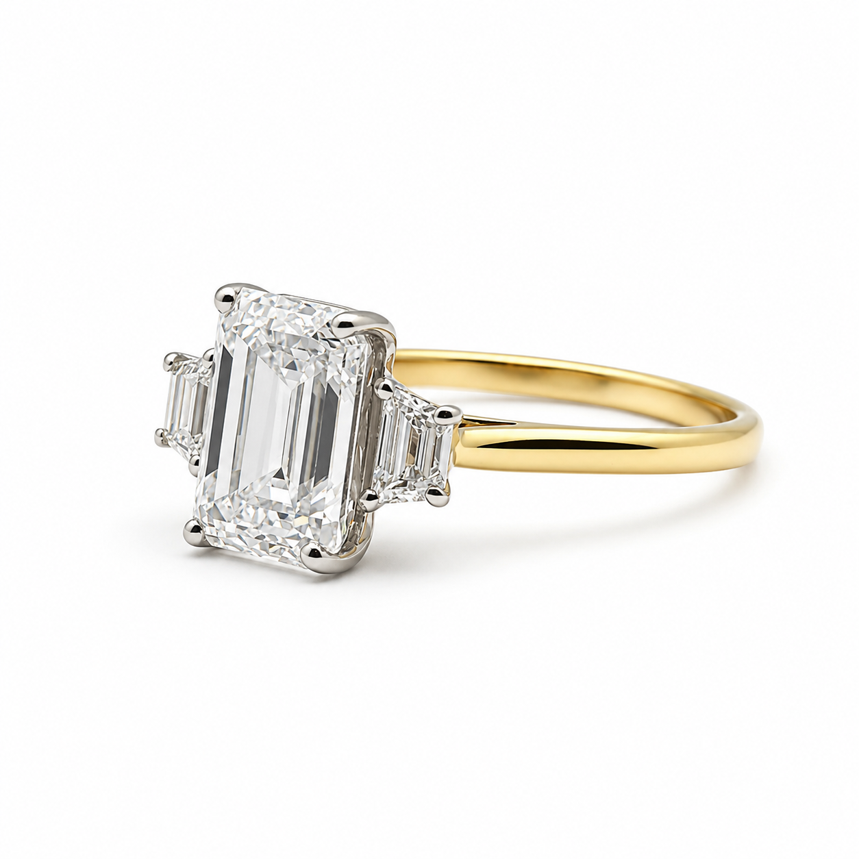 3ct Emerald Cut Diamond and Trapezoid Diamond Trilogy Ring in 18ct Yellow Gold with White Gold Head