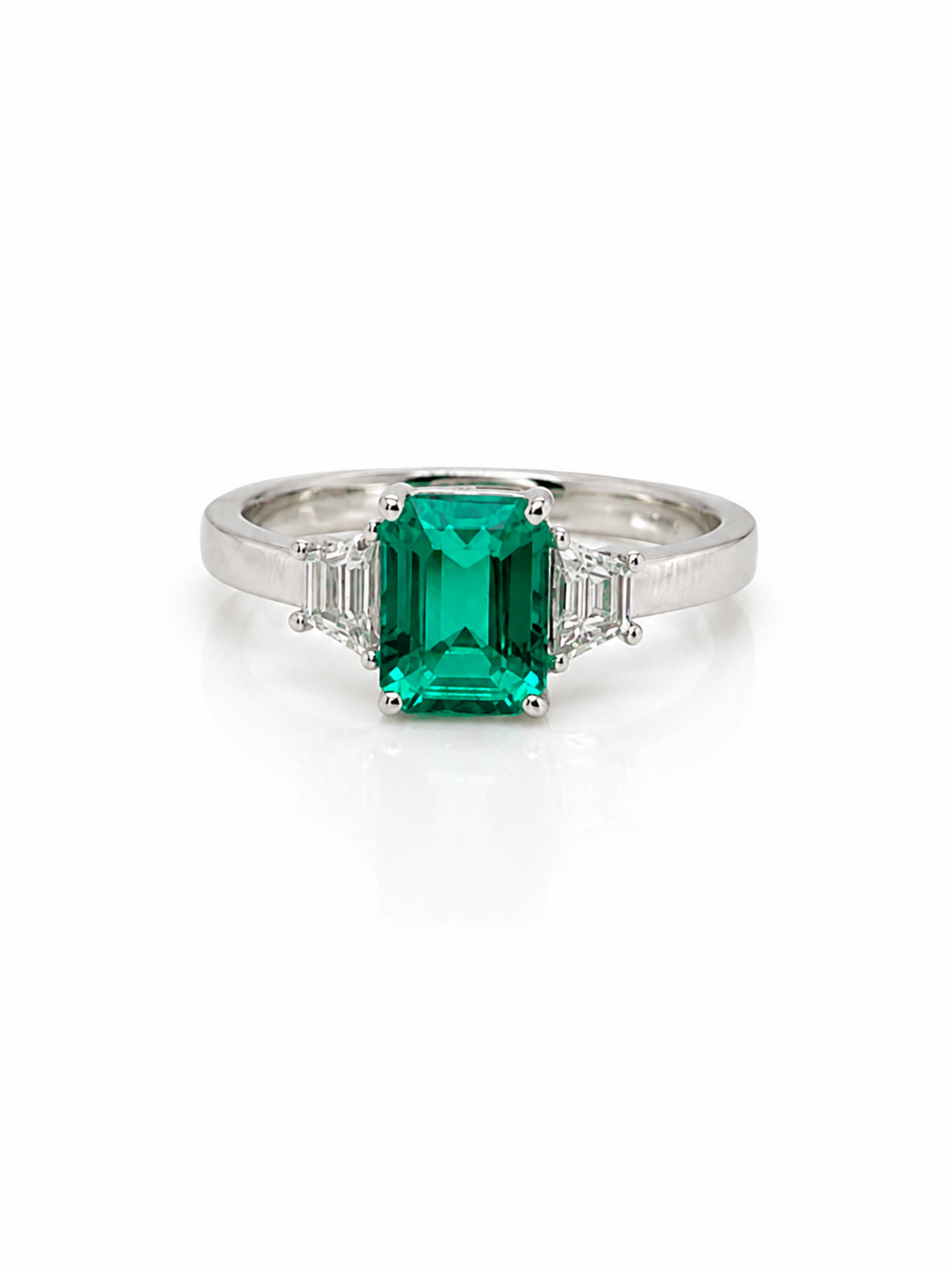 Emerald and Trapezoid Diamond Trilogy Ring in Platinum