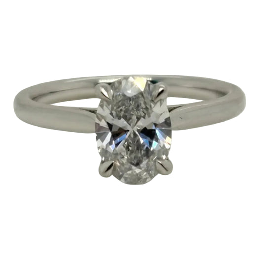 Diamond ring with a white gold band on a light gray background